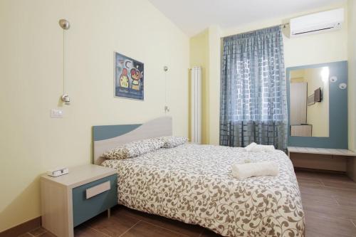a bedroom with a bed and a table and a window at Homesuitehome in Rome