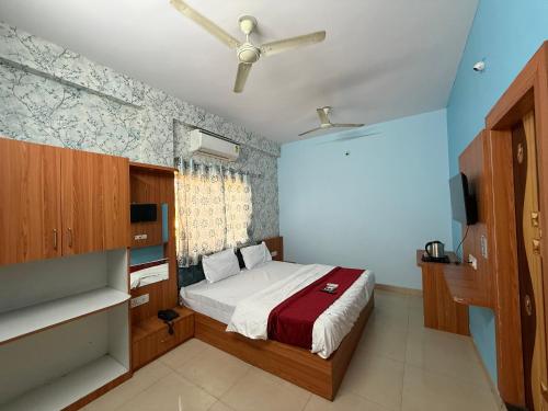 a bedroom with a bed and a ceiling fan at Hotel Sutlaj in Indore