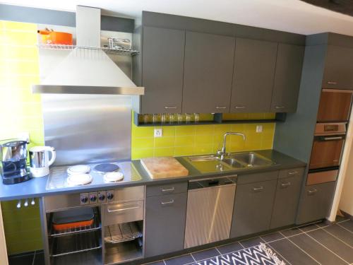 a kitchen with a sink and a counter top at Apartment Rilkedorf Raron in Raron