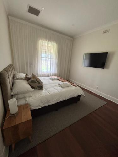 a bedroom with a bed and a couch and a television at Annabelle's Cottage in Clare