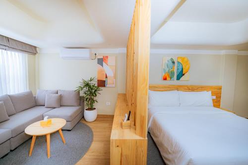 a living room with a bed and a couch at 31 Park Hotel in Pokhara