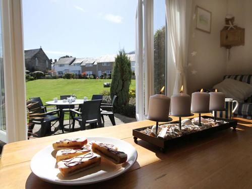a table with three plates of hot dogs on a table at Bwthyn y Mor in Porthmadog