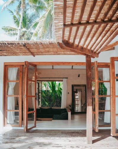 an open living room of a house with glass doors at Marevka - Pool Villa with garden in General Luna