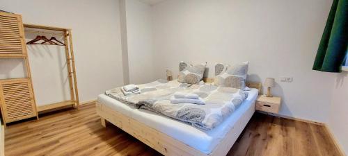 a bedroom with a bed with towels on it at Alpenrose Ferienwohnung in Balderschwang