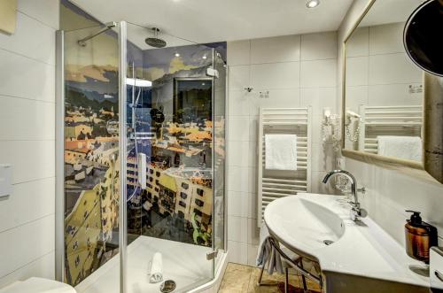 a bathroom with a shower and a sink at Hotel Goldener Adler, BW Signature Collection in Innsbruck