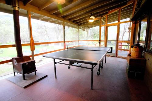 a ping pong table in the middle of a room at The Cabin at Deer Hollow in Three Rivers