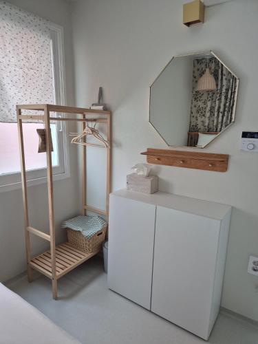 a room with a white cabinet and a mirror at 어게인수영 in Suyŏng