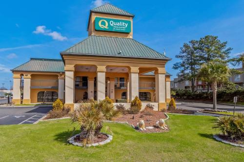 a hotel with a clock tower on top of a building at Quality Inn & Suites Florence Civic Center in Florence