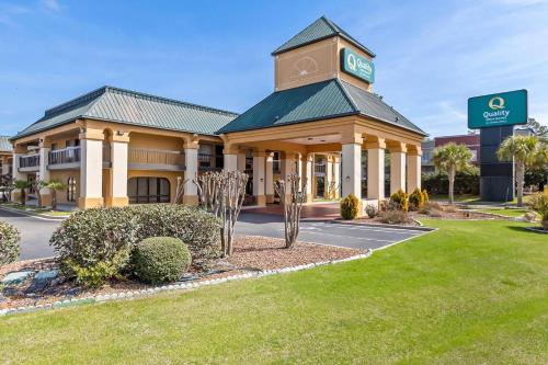 a hotel with a clock tower on top of a building at Quality Inn & Suites Florence Civic Center in Florence