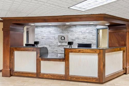 a lobby with a waiting area with a stone wall at Quality Inn & Suites Florence Civic Center in Florence