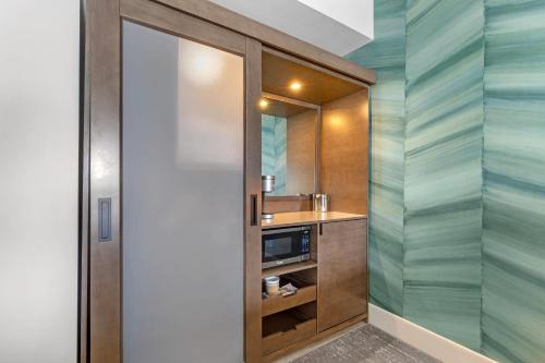 a small bathroom with a sink and a mirror at Cambria Hotel Ocean City - Bayfront in Ocean City