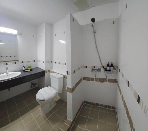 a bathroom with a toilet and a sink at Sena House in Bangkok