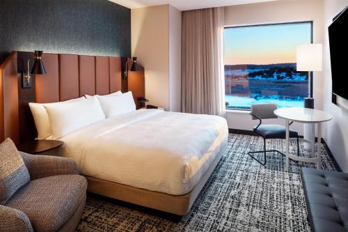 a hotel room with a bed and a window at Tempo By Hilton Manassas in Manassas