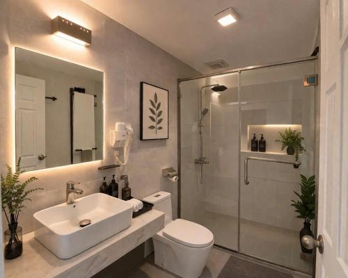 a bathroom with a toilet and a sink and a shower at Eco Nest Hotel 6 Đình Ngang in Hanoi