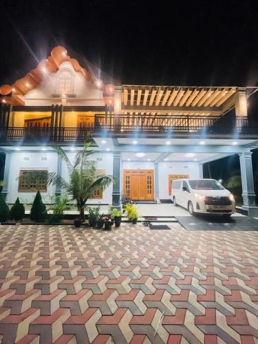 a white car parked in front of a house at MTR Guesthouse in Point Pedro