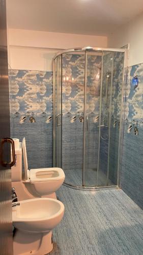 a bathroom with a toilet and a shower at Coco Drift Hostel Hiriketiya in Hiriketiya