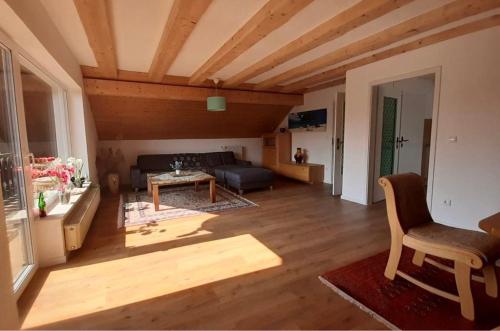 a living room with a couch and a table at Ferienwohnung Lechauszeit in Landsberg am Lech