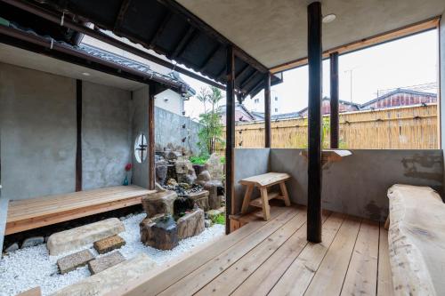 a room with a wooden deck with a bench at 穂庵-Hoan- in Tanabe
