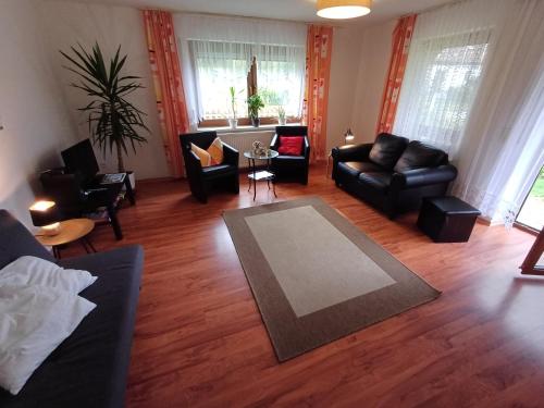 a living room with a couch and a table at Ferienwohnung am Ulrichsgrünbach in Waldmünchen