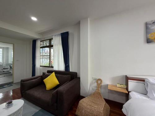 a living room with a couch and a bed at S Hostel Sukhumvit 48 in Bangkok