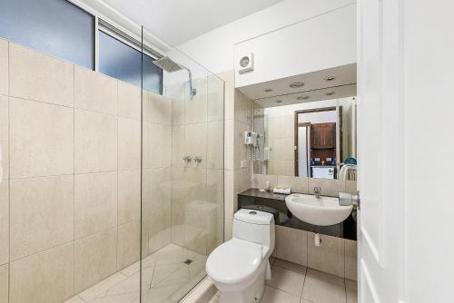 a bathroom with a toilet and a sink at Quality Hotel Colonial Launceston in Launceston