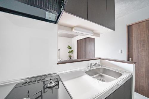 a kitchen with a sink and a counter top at Hills Niseko 206 in Wada