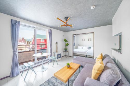 a living room with a couch and a table at Hills Niseko 206 in Wada