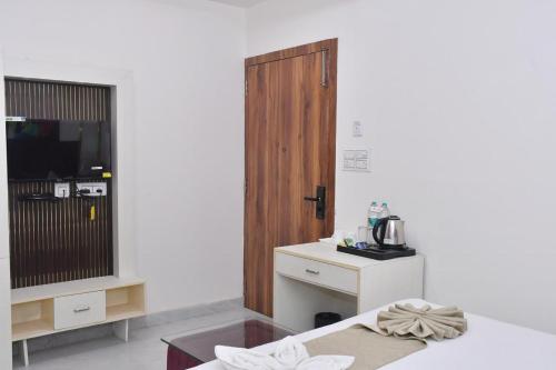 a room with a table and a door and a counter at Bisaka Hotels in Patna