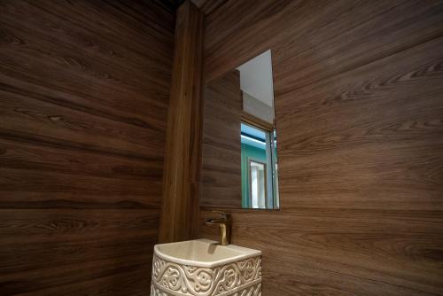 a bathroom with a sink and a mirror at Zafaron Premium Hotel in Chimgan