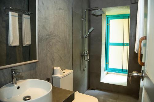 a bathroom with a sink and a toilet and a shower at KAHA by TONIK, Talpe - Pool & Garden in Talpe