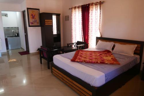 a bedroom with a bed and a television in it at Heritage Vagamon Cottages in Idukki