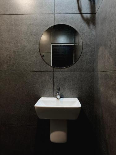 a bathroom with a sink and a mirror on the wall at Havana Beach Villa in Alleppey