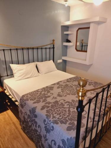 a bedroom with a bed with a mirror and a bed sidx sidx sidx at Traditional mama house in Skala Sotiros