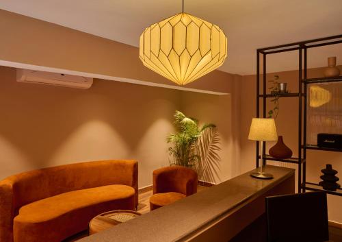 a living room with a table and chairs and a lamp at Minimalist - The Varanasi Edit in Varanasi