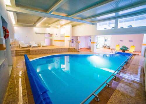 a large swimming pool in a building at Palace Grand 1, Palace Grand 2 in Nový Smokovec