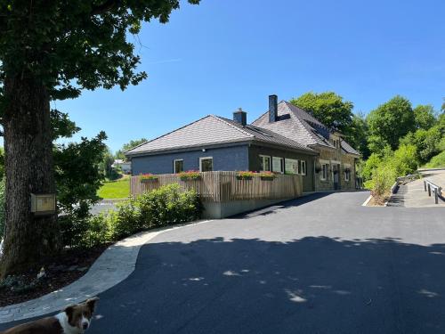 a house with a cat walking down a driveway at # A Mont Nos'Hôtes in Malmedy