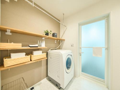 a washing machine in a room with a window at HUG me Ocean awaji in Sumoto
