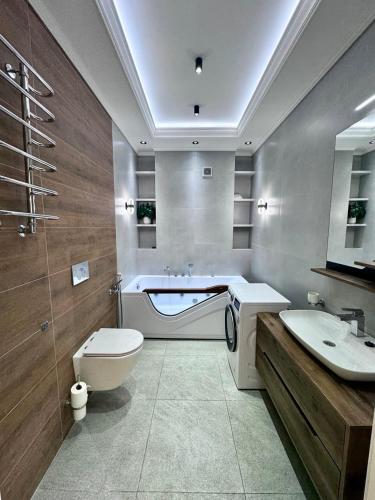 a bathroom with a toilet and a sink and a tub at Boulevard in Samarkand