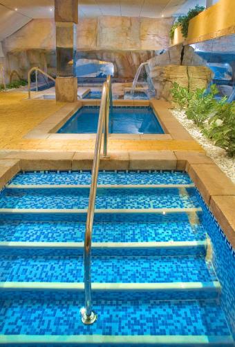 a plunge pool in a spa with blue water at Senator Cádiz in Cádiz