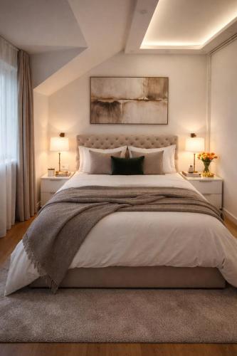 a bedroom with a large bed with two lamps at Garden lux in Belgrade