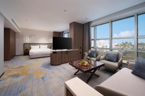 a large hotel room with a bed and a television at Liuhua Hotel in Guangzhou
