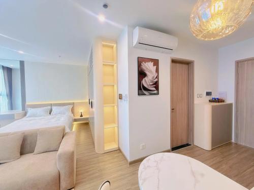 a white bedroom with a bed and a couch at Homestay Ocean Park Building P3 in Gia Lâm Pho