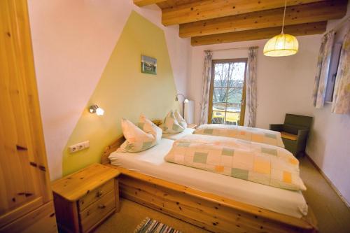a bedroom with a bed and a window at Wohlfühlbauernhof in Geslau