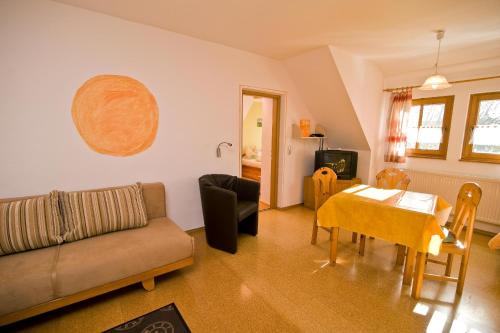 a living room with a couch and a table at Wohlfühlbauernhof in Geslau