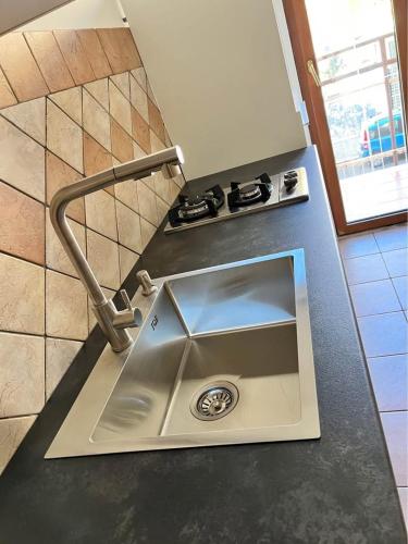 a kitchen counter with a sink and a stove at Corso Messina in Crotone