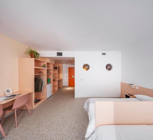 a bedroom with a bed and a desk at Hotel Valencia Tower in Burjassot