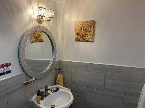a bathroom with a sink and a mirror at Jubilee Gardens Freeport in Freeport