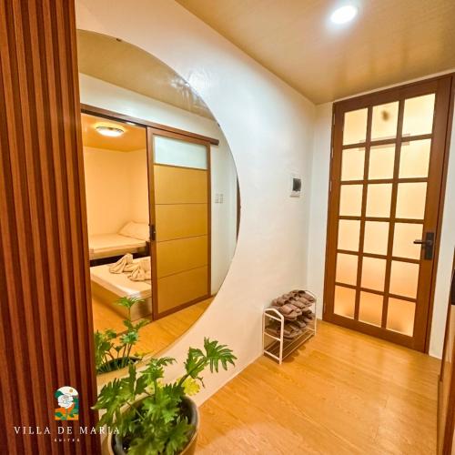 a room with a circular hallway with a bed and a mirror at Villa de Maria Suites in Binungan