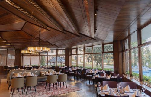 a dining room with tables and chairs and windows at Hotel Yak & Yeti in Kathmandu