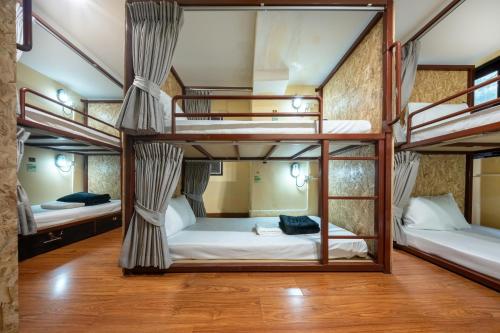 a room with four bunk beds in a hostel at WUA LAI Boutique Hotel Chiang Mai in Chiang Mai